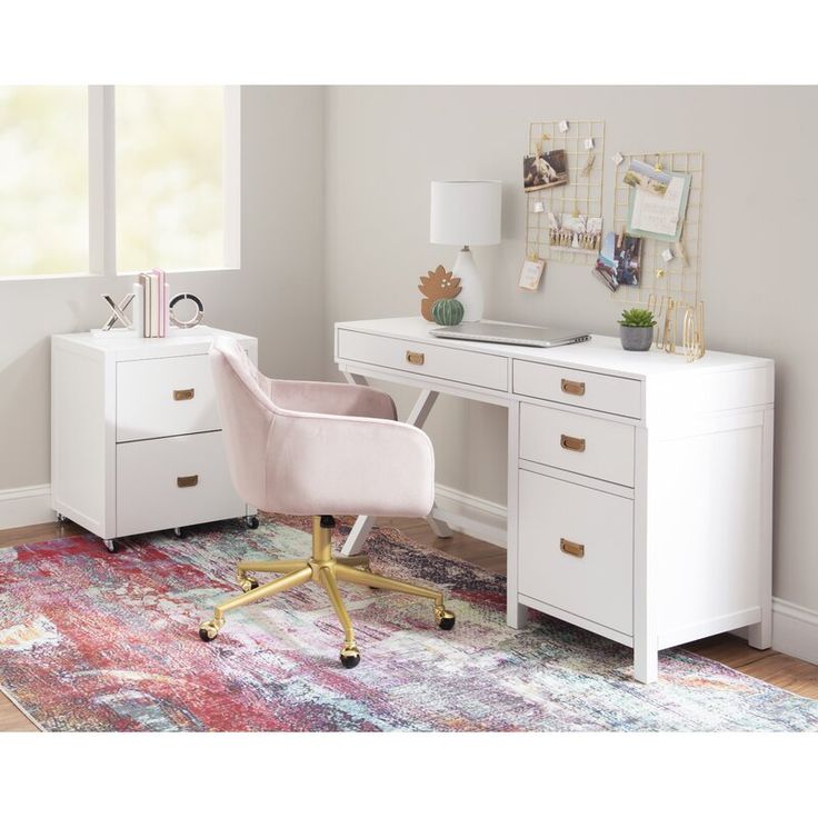 a white desk with a pink chair in front of it and pictures on the wall