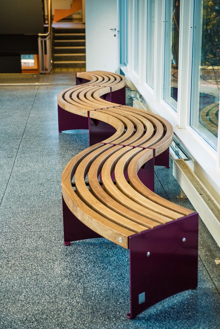 two benches sitting next to each other in front of a window