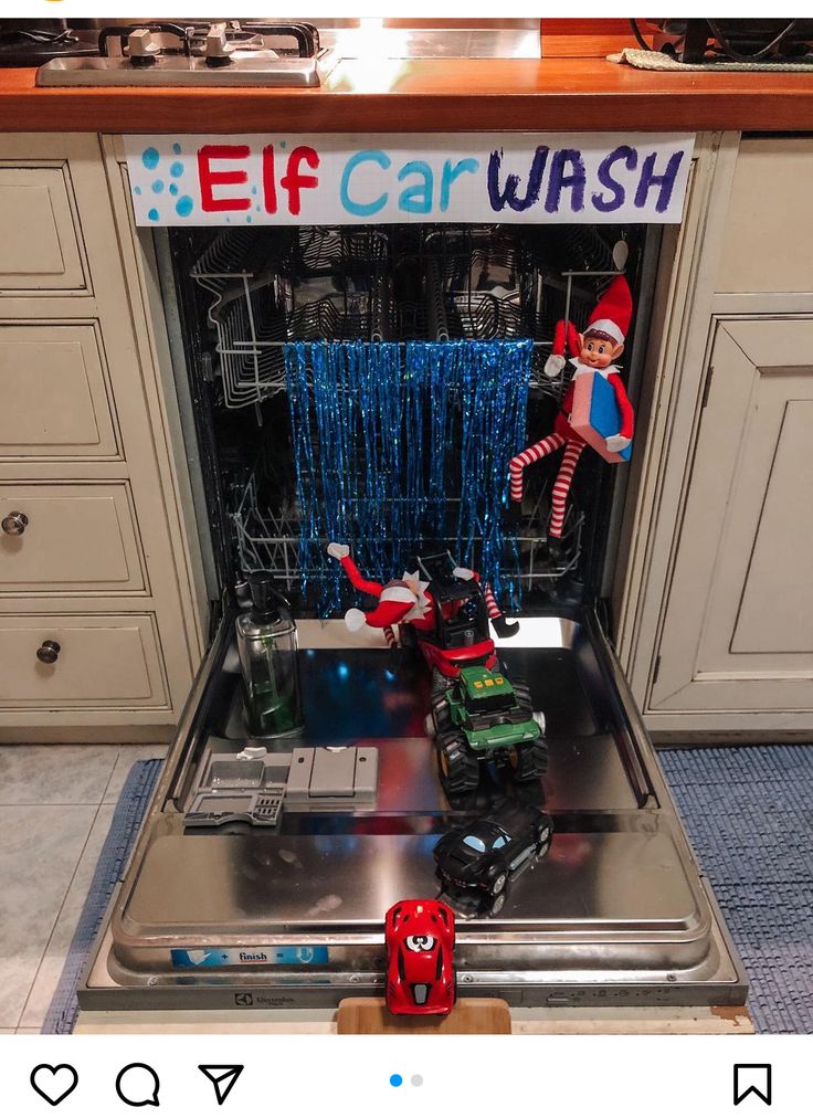 an elf is sitting in the dishwasher