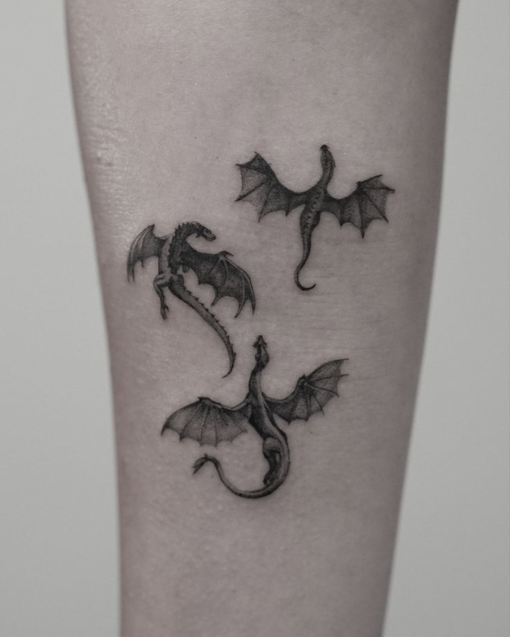 a small dragon tattoo on the leg