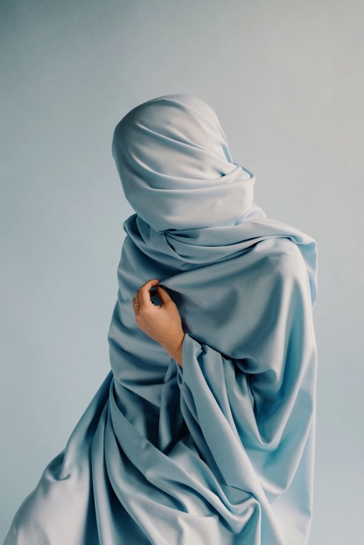 a painting of a person wrapped in a blue cloth