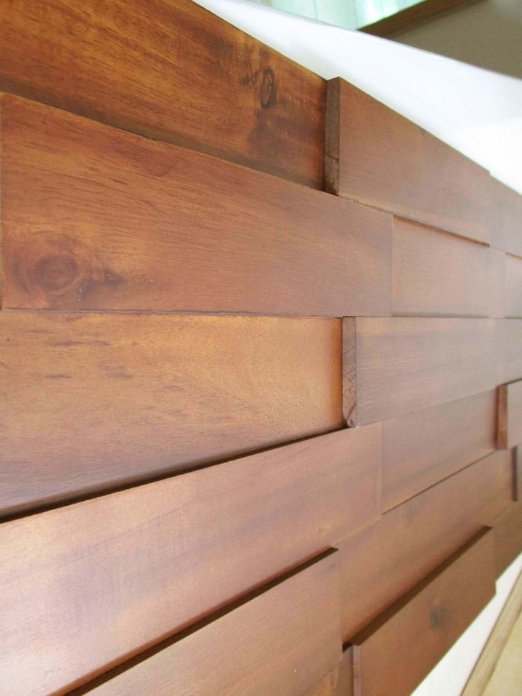 wood paneling on the side of a bed with no sheets or headboard covers