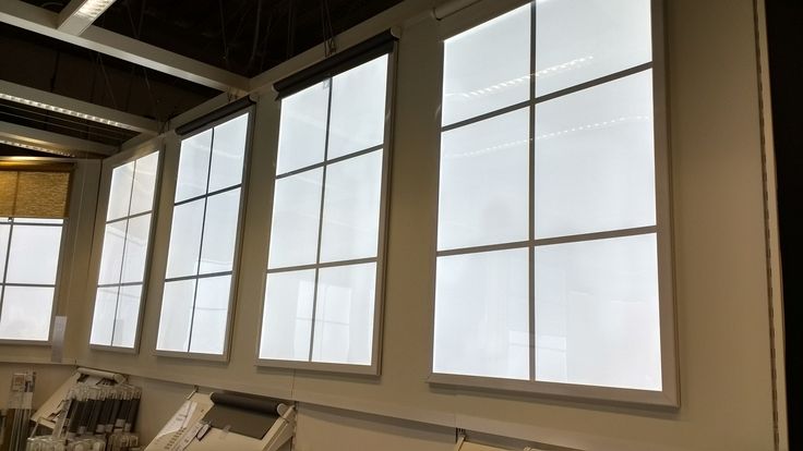 three large windows in a room with white walls