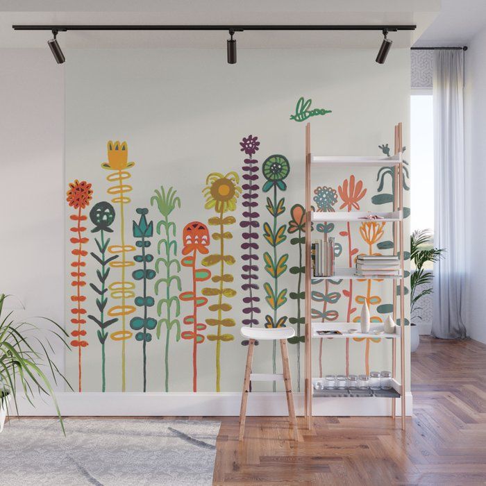 a wall mural with flowers painted on it in a living room next to a window