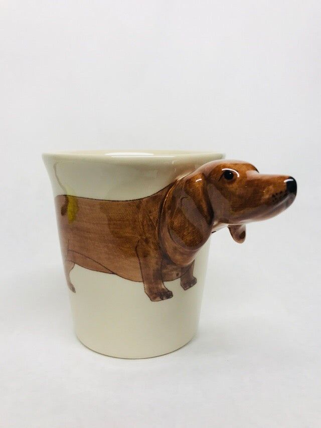 a ceramic dachshund dog mug sitting on a white surface