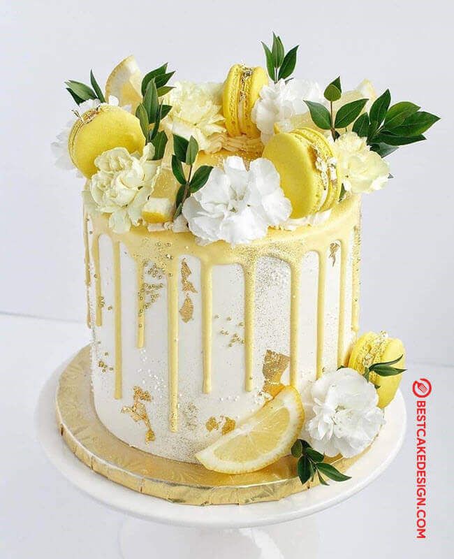 a white cake with lemons and flowers on top