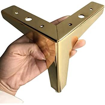 a hand is holding a metal object with holes in the middle and two fingers on it