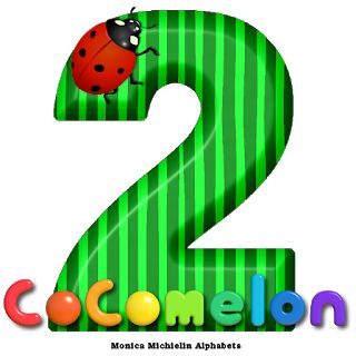 the number two with a ladybug sitting on it's back and green stripes