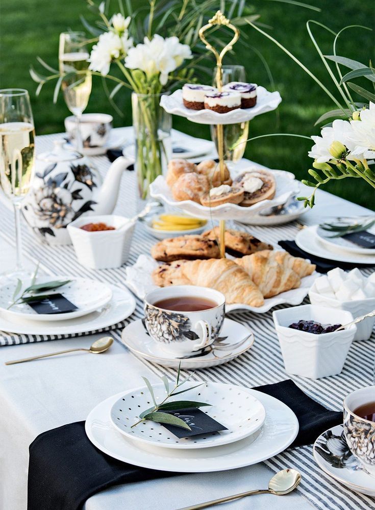 a table topped with plates and cups filled with food