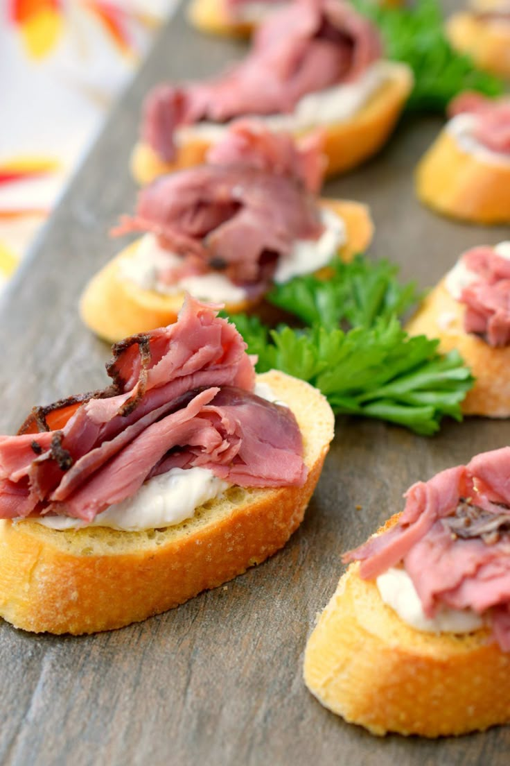 small appetizers with meat and cheese on bread