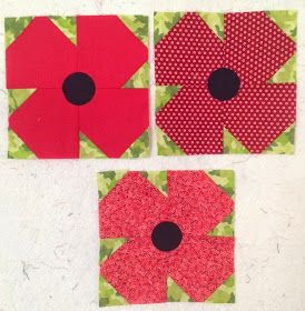 three red and green flower blocks on a white table top with black circles in the center