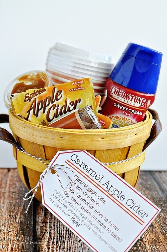 a basket filled with food and drinks next to a sign that says apple cider