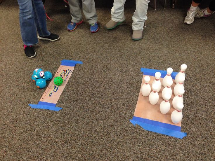 several people are standing around with plastic balls on the ground and in front of them