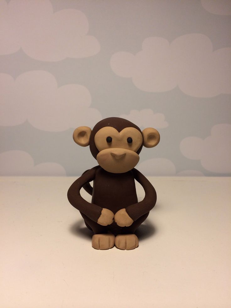 a small toy monkey sitting on top of a table