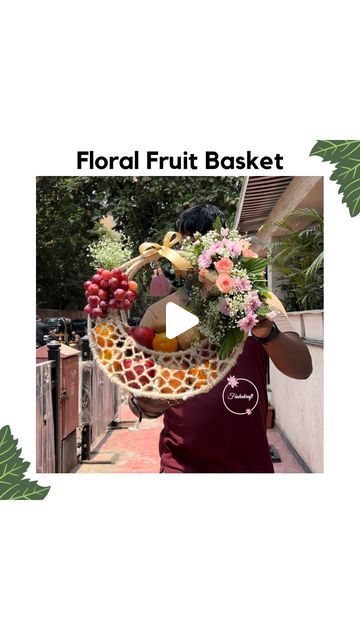 a woman holding a basket filled with fruits and vegetables in front of her face, text reads floral fruit basket