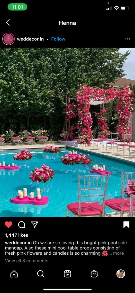 an image of a pool with chairs and flowers on it's back drop down