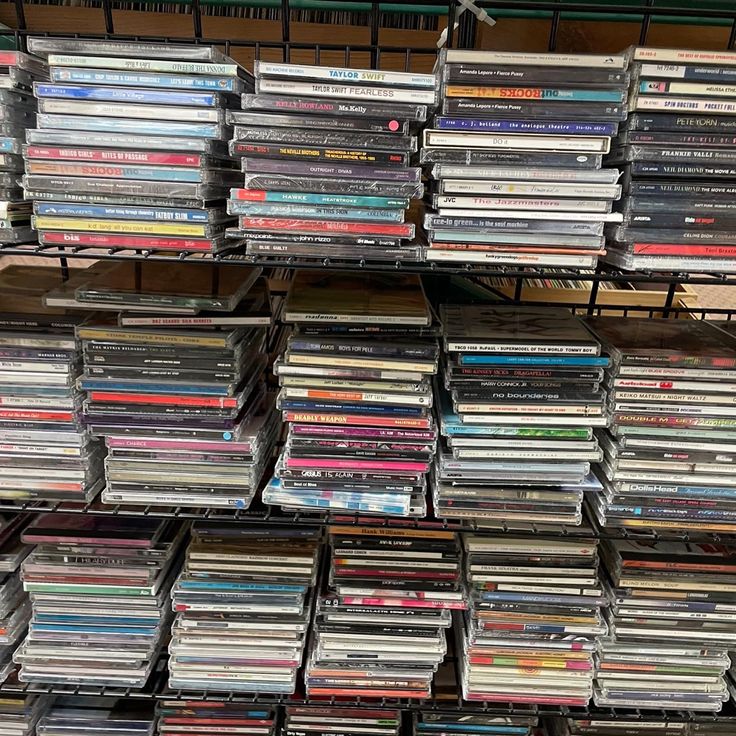 a large amount of cds are stacked on top of each other