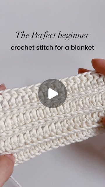 the crochet stitch for a blanket is being worked on by someone using scissors