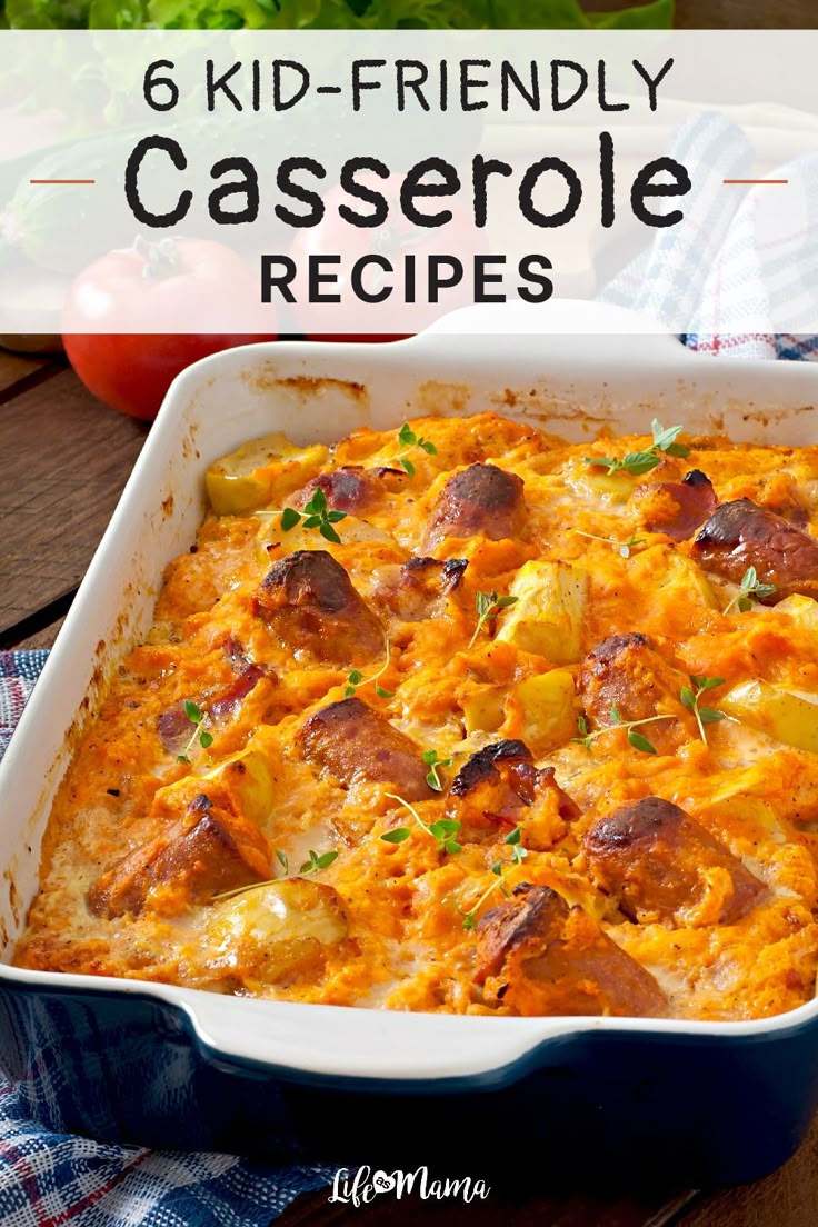 a casserole dish with sausage and potatoes in it on a table next to vegetables