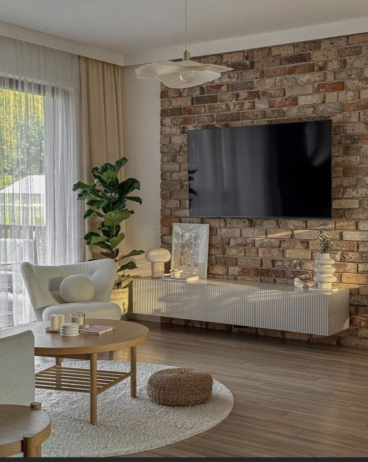 a living room filled with furniture and a flat screen tv mounted on the wall above a fireplace