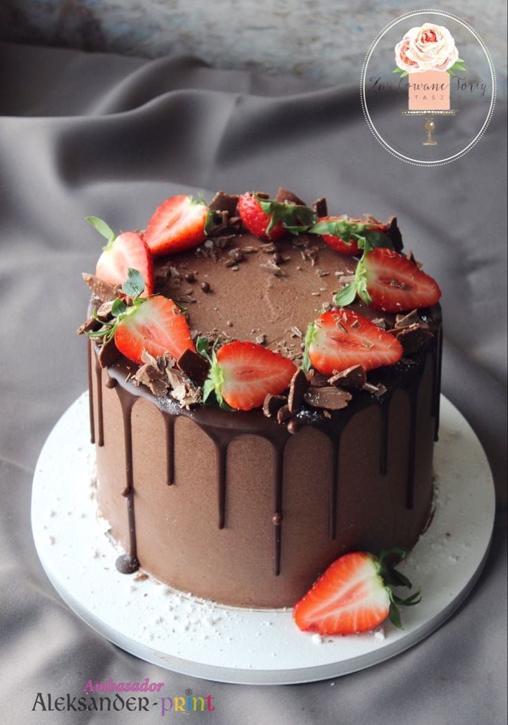 a chocolate cake with fresh strawberries on top