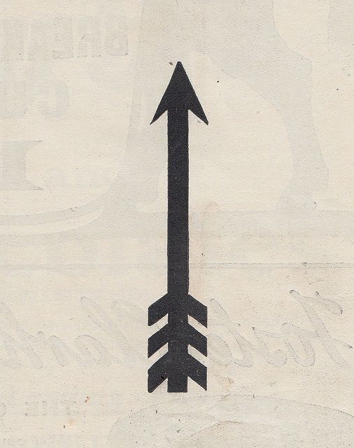 an arrow drawn on the side of a white paper