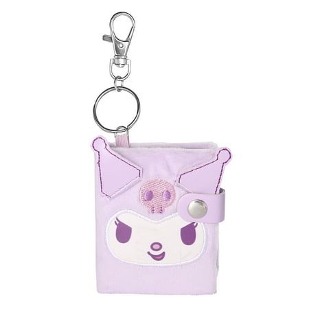 a small purple bag with a face on it and a keychain hanging from the front