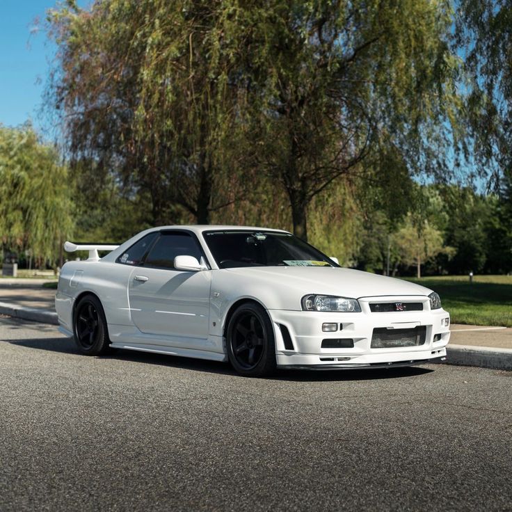 the white car is parked on the street