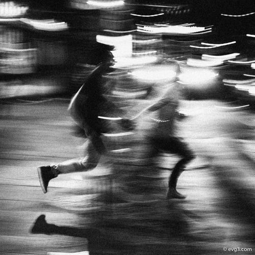 blurry image of people running in the street