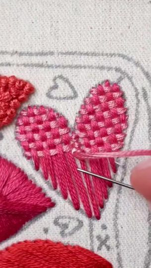 someone is stitching hearts on a piece of fabric