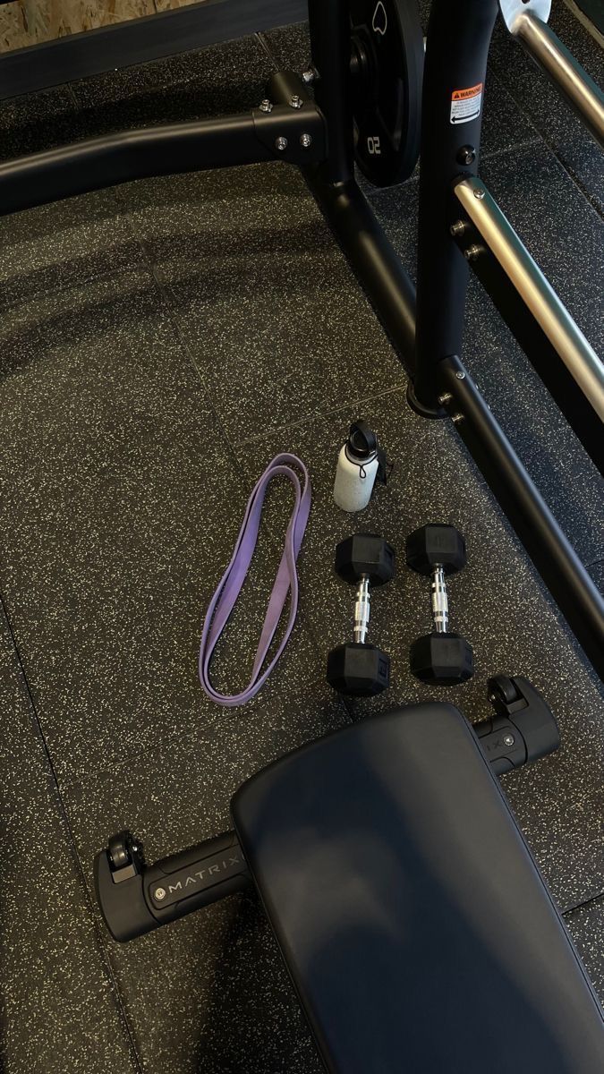 the gym equipment is sitting on the floor in front of the racked door to the vehicle