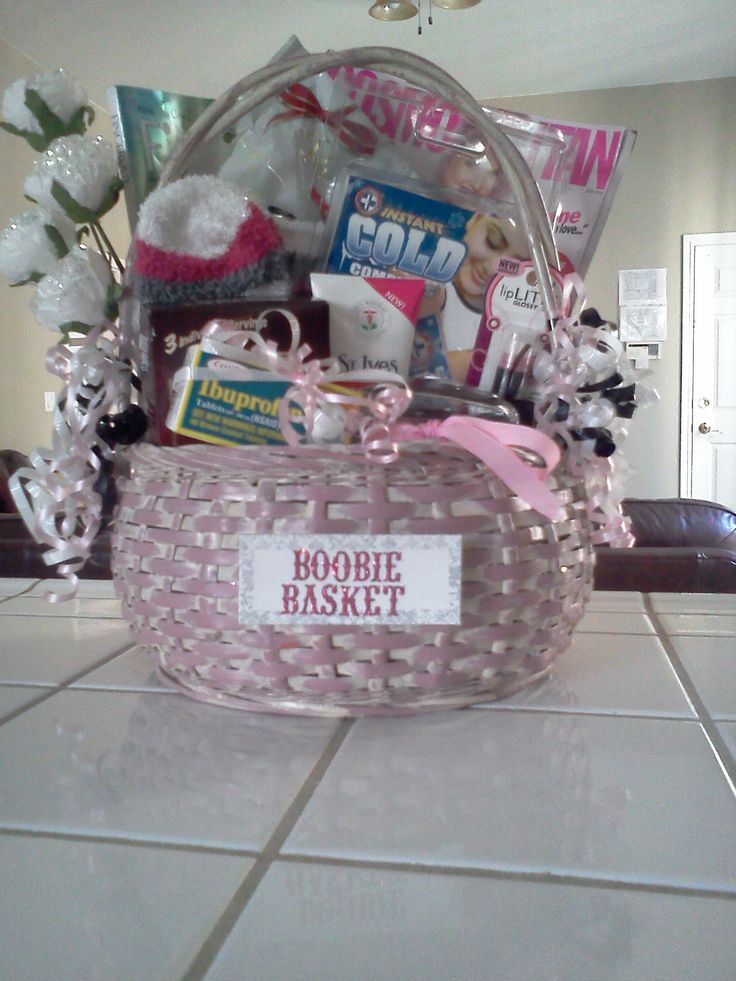 a pink basket filled with lots of items on top of a white tiled countertop