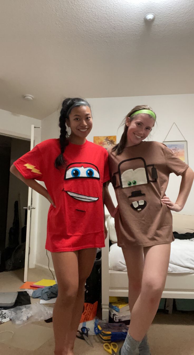 two girls in costumes standing next to each other