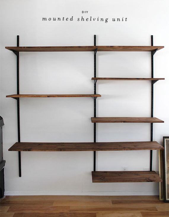 the shelves are made of wood and have metal bars on each side, along with white walls