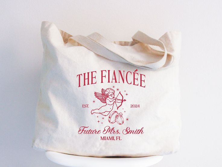 a white tote bag sitting on top of a white counter next to a wall