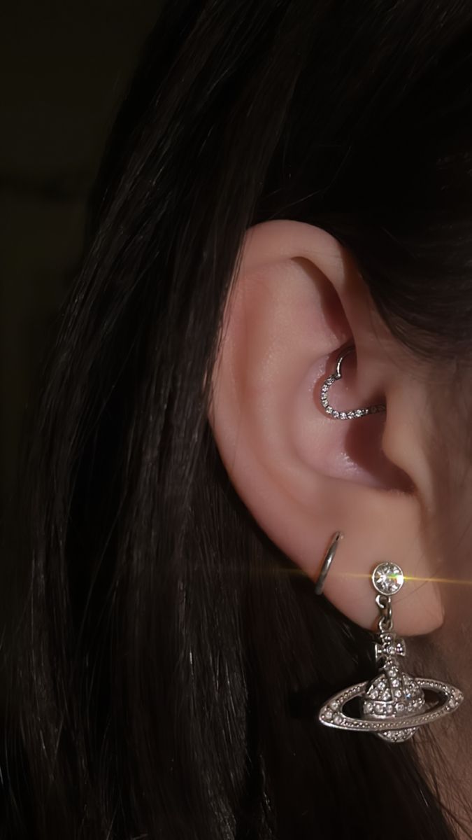 a close up of a person's ear with two piercings on top of it