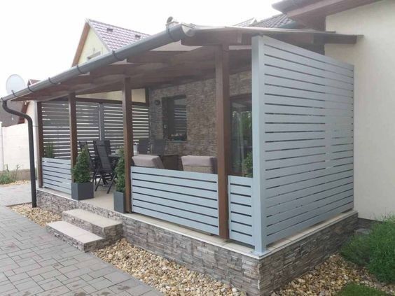 a house with a covered patio and stone steps