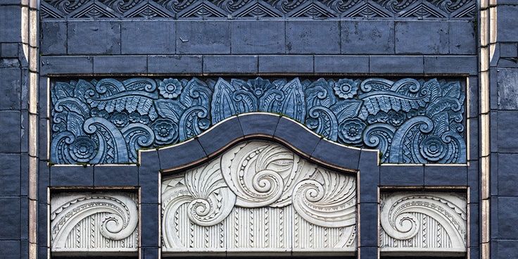 an ornate blue and white window frame on a building