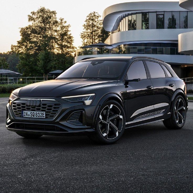 a black suv parked in front of a building