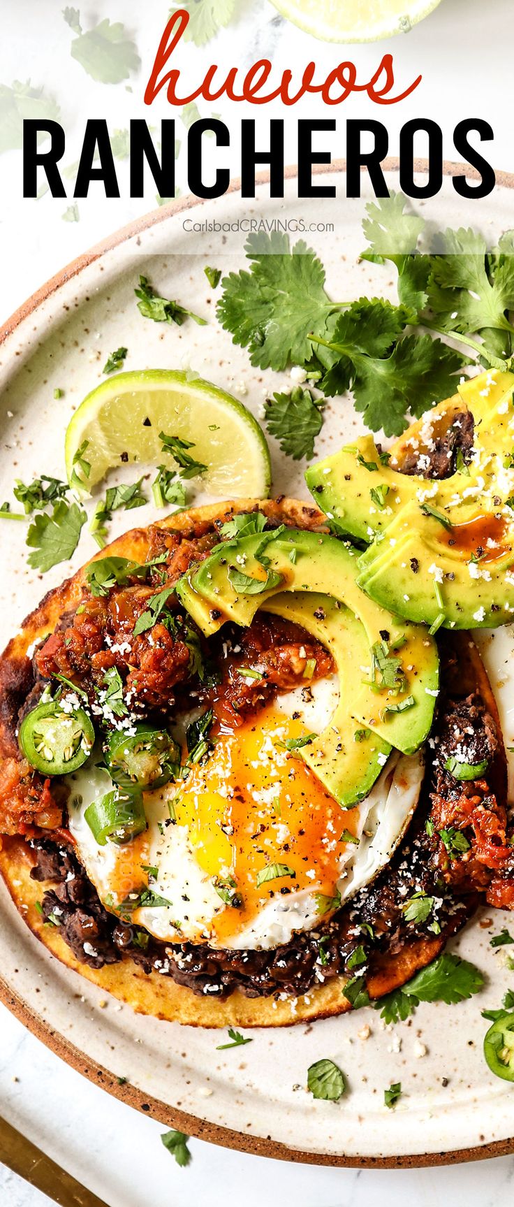 an egg and avocado dish on a plate with the title overlay reads, mexican hueros rancheros