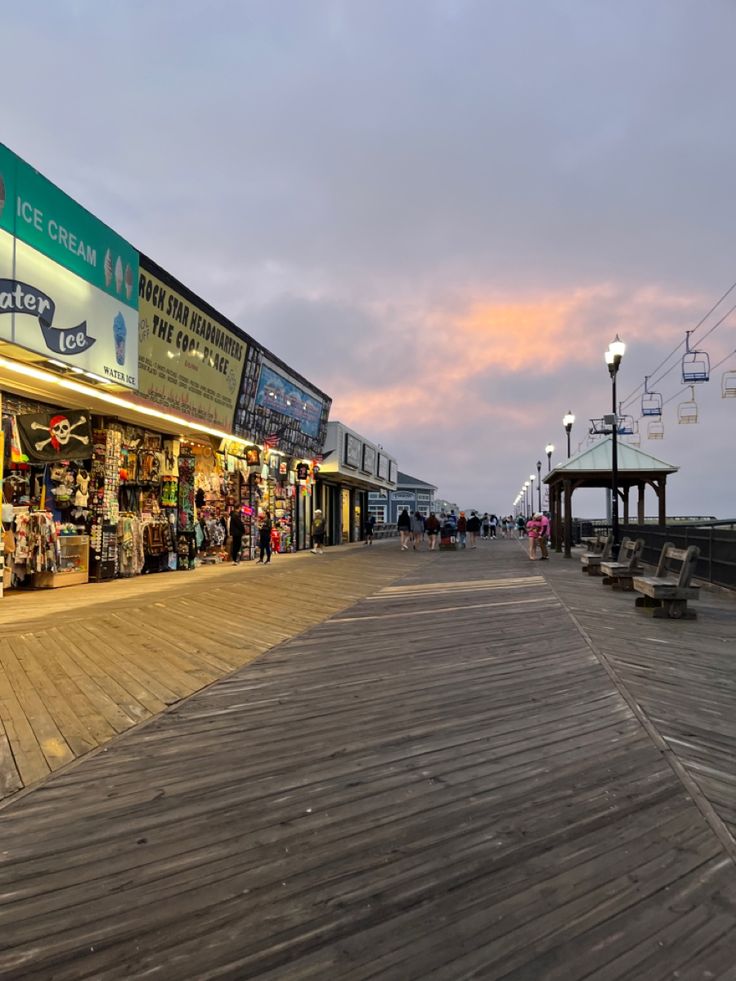 the boardwalk is lined with shops and people