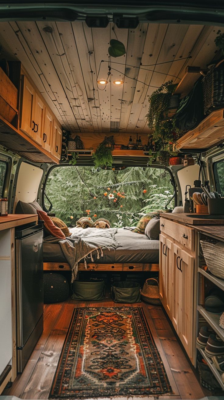 the interior of a camper van with wood flooring and walls, including cabinets