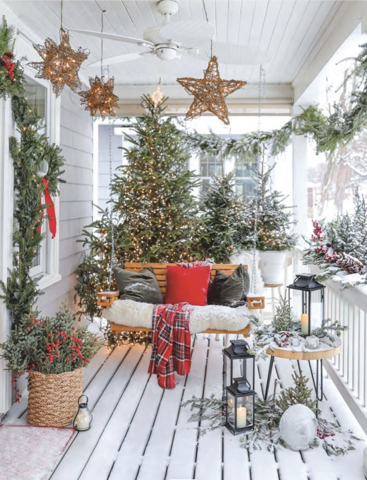 a porch covered in christmas decorations and lights