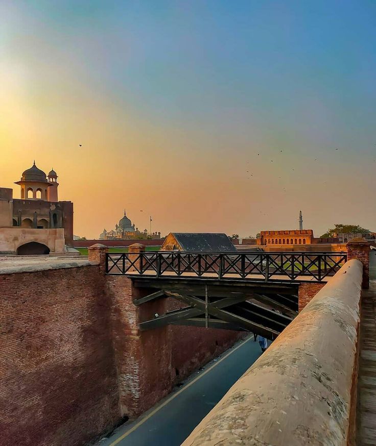 a bridge over a river with buildings in the background