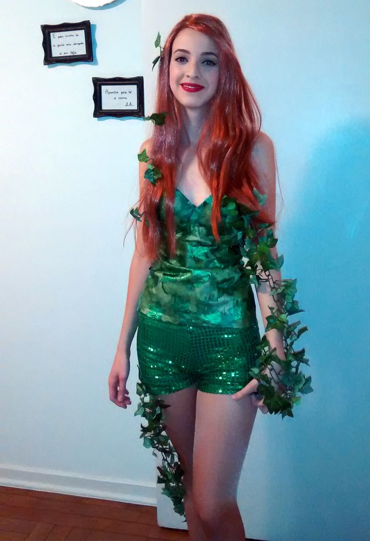 a woman dressed in green is posing for the camera