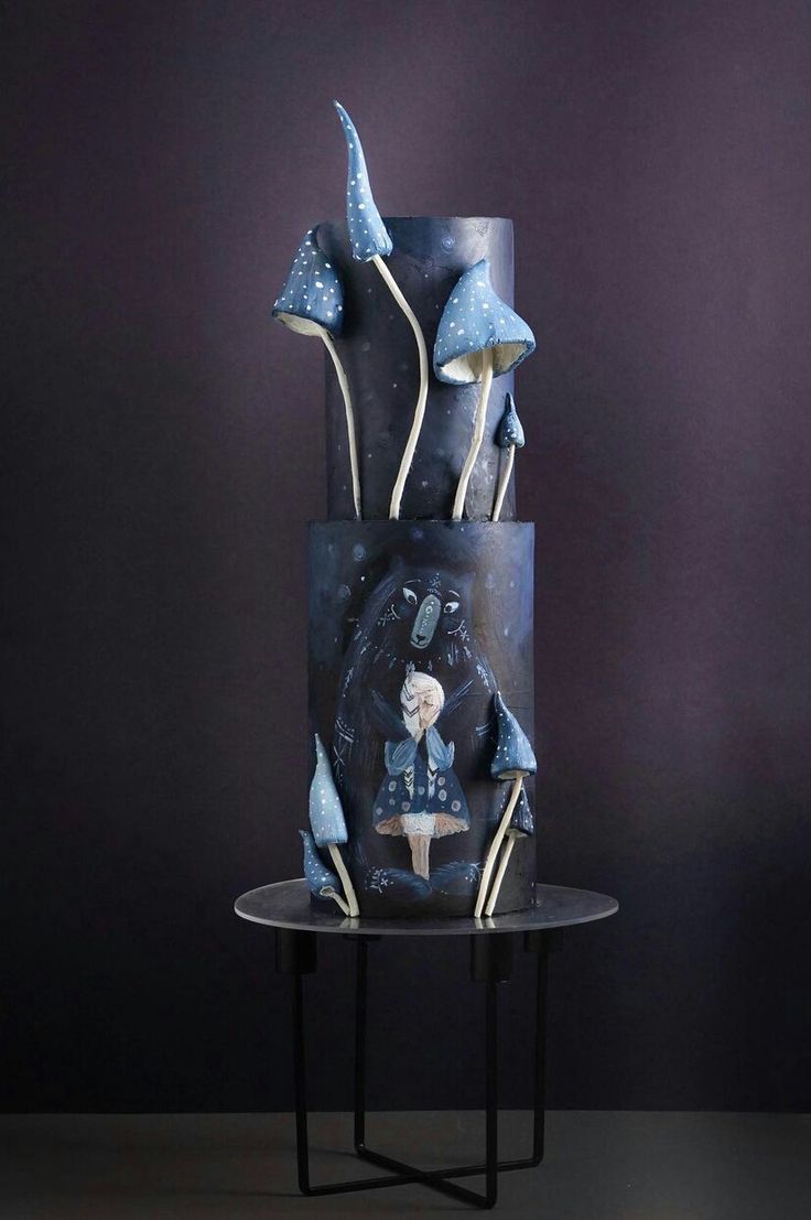 a three tiered cake decorated with blue and white frosting