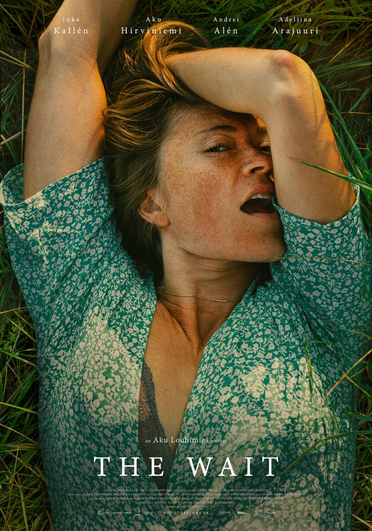 a woman laying in the grass with her hands on her head and eyes closed, looking up