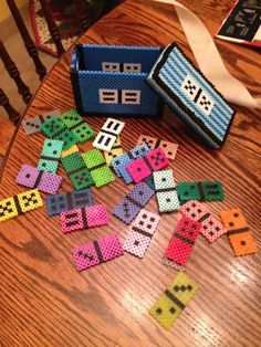 a wooden table topped with lots of different types of letters and numbers made out of perler beads