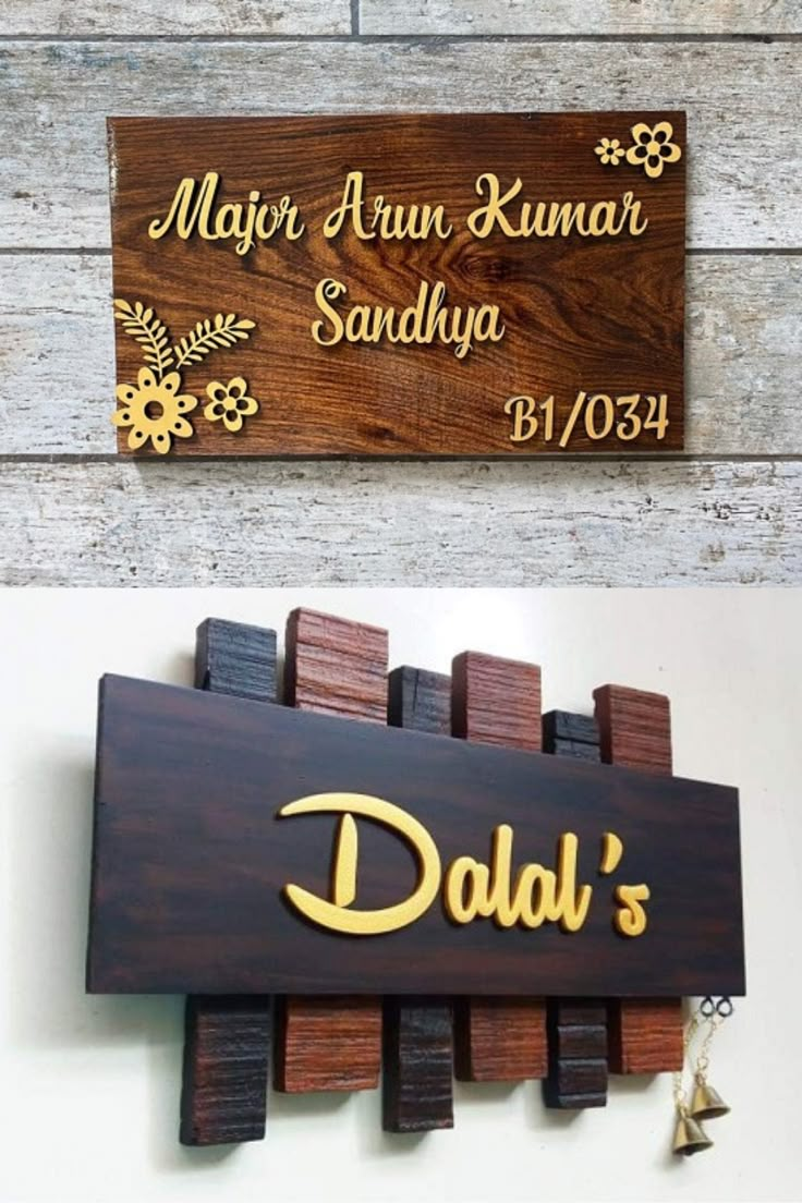 two wooden signs hanging from the side of a wall next to each other with names on them