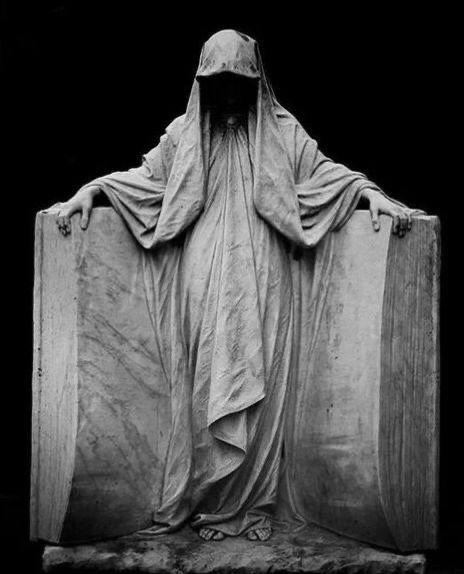 black and white photograph of the statue of jesus with his arms wrapped around two suitcases